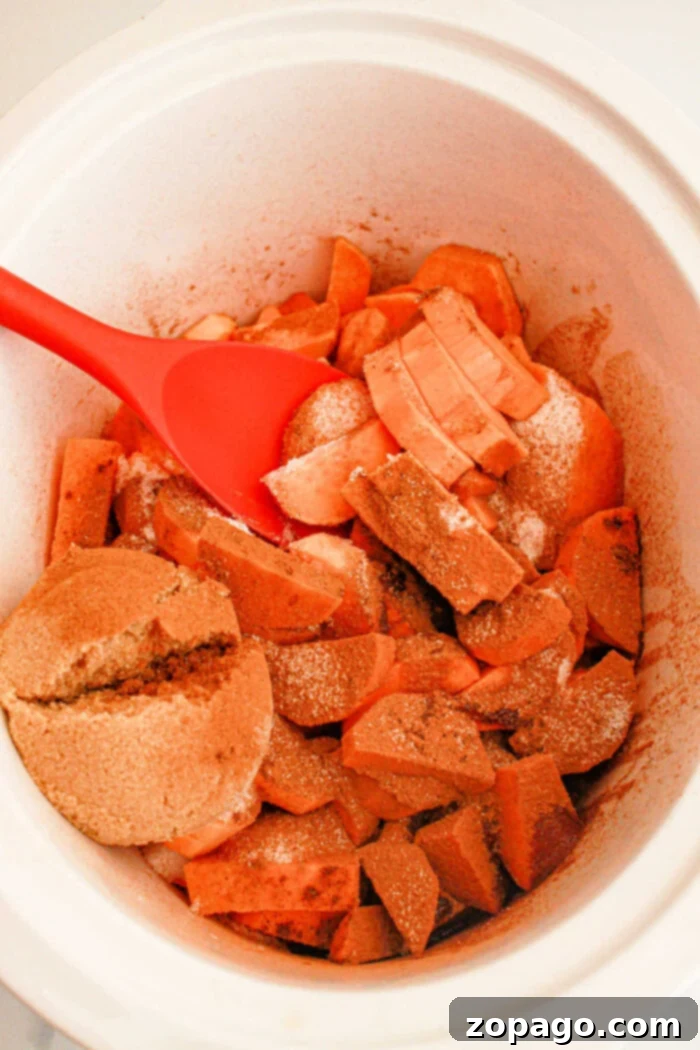 Crockpot Candied Yams 4 Slow cooker filled with sweet potato slices ready to cook.