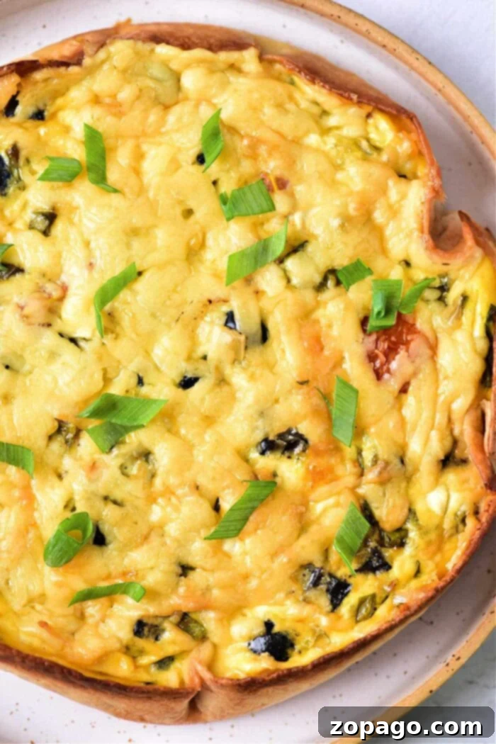 Wholesome Cottage Cheese Quiche 2 A vibrant flat lay shows ingredients for Cottage Cheese Quiche: grated cheese, a fresh egg, chopped spinach, creamy cottage cheese, bright cherry tomatoes, earthy mushrooms, and a soft tortilla, with two elegant wooden scoops nearby.