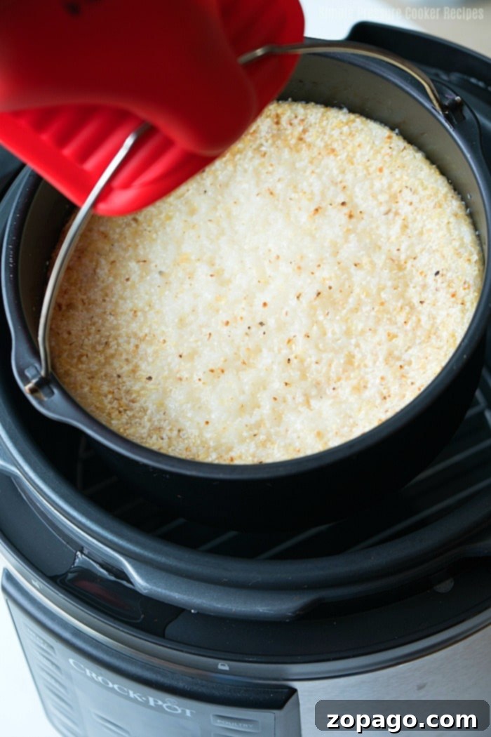 No-Fuss Pressure Cooker Grits 4 A close-up shot of perfectly cooked, creamy and cheesy grits from the Crock Pot Express, ready to be enjoyed.