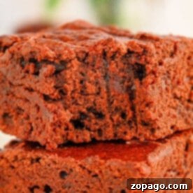 Close-up of two stacked black bean brownies made with brownie mix with a soft, crumbly texture, perfectly showcasing the rich mix of flavors.