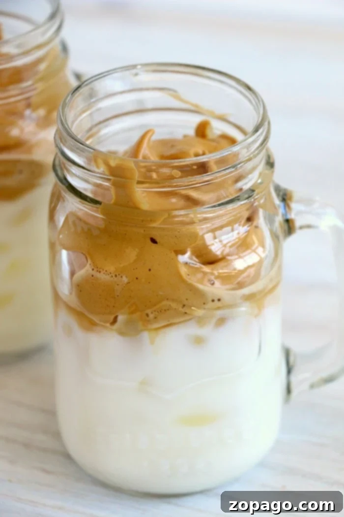 Easy 3-Ingredient Coffee Creamer 2 A tall glass of Dalgona whipped coffee topped with whipped cream and chocolate shavings.