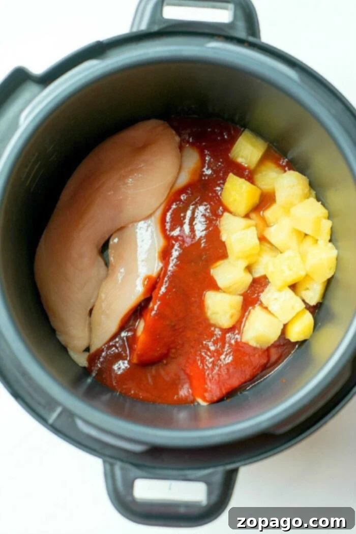 Moist, flavorful shredded BBQ chicken cooked in a Crock Pot Express, ready for tacos.