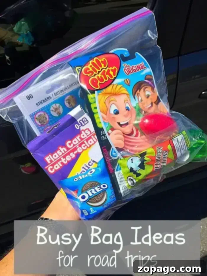 Discover top busy bag ideas for road trips, packed with fun activities and treats to keep kids happy and entertained during long car journeys. #roadtrip #busybags #kidsactivities A hand holds a clear ziplock bag brimming with road trip busy bag essentials like Silly Putty, flashcards, Oreo cookies, and a small juice pouch. The text on the image reads, 'Busy Bag Ideas for road trips.'