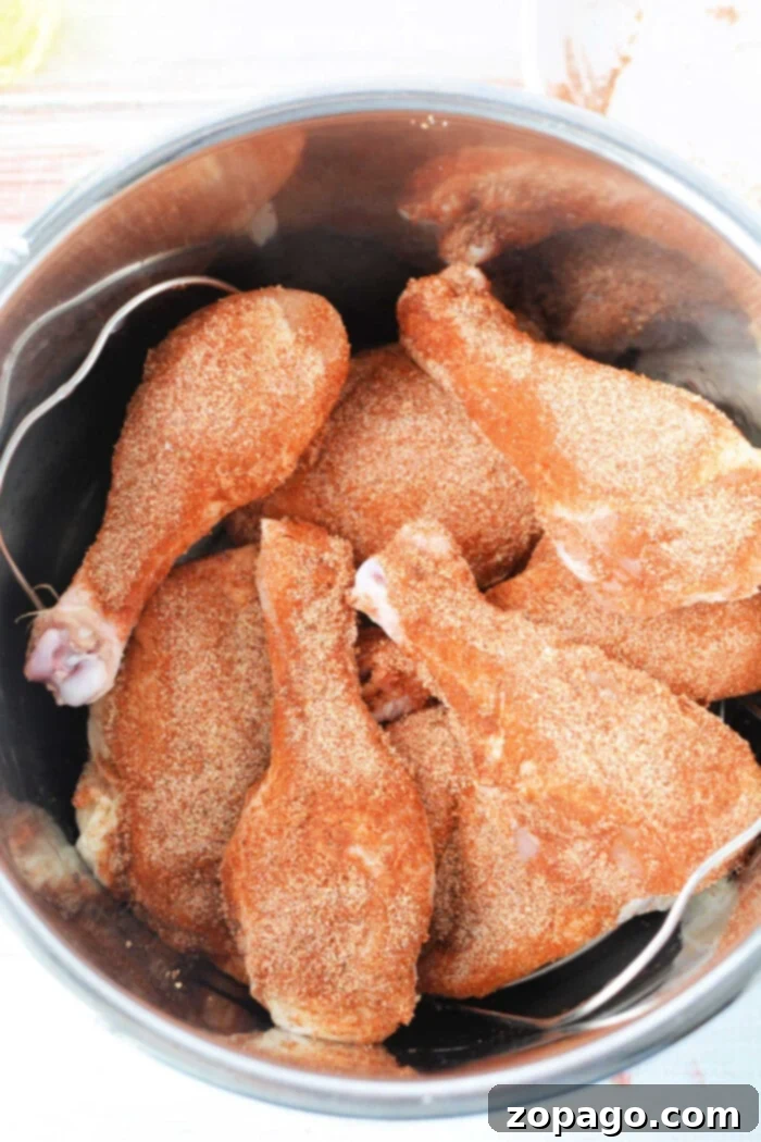Speedy Pressure Fried Chicken 4 Chicken drumsticks, expertly seasoned and nestled in a metal pot, are transformed into succulent fried chicken using the magic of a pressure cooker.