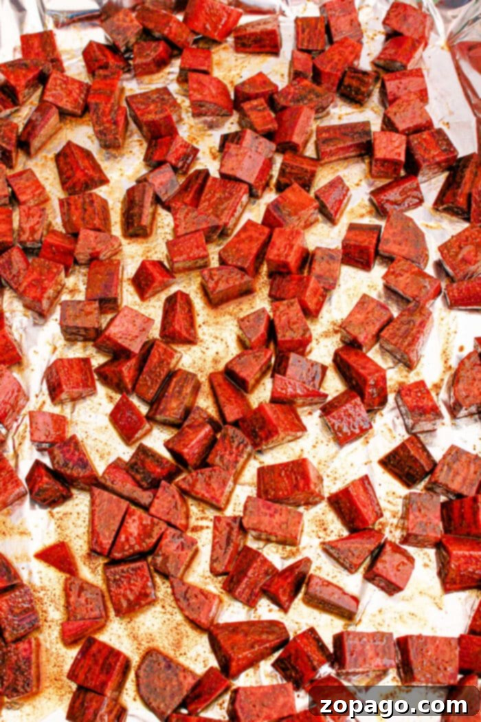 Vibrant Purple Sweet Potato Creations 5 Cubed roasted purple sweet potatoes on a foil-lined baking sheet, seasoned and evenly spread.