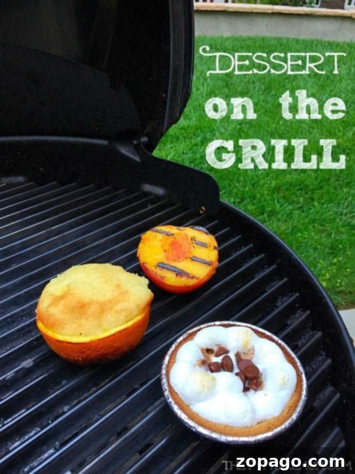A vibrant grill scene featuring a halved grilled peach, an orange filled with cake batter, and a small S'mores pie, all showcasing delicious BBQ dessert recipes.