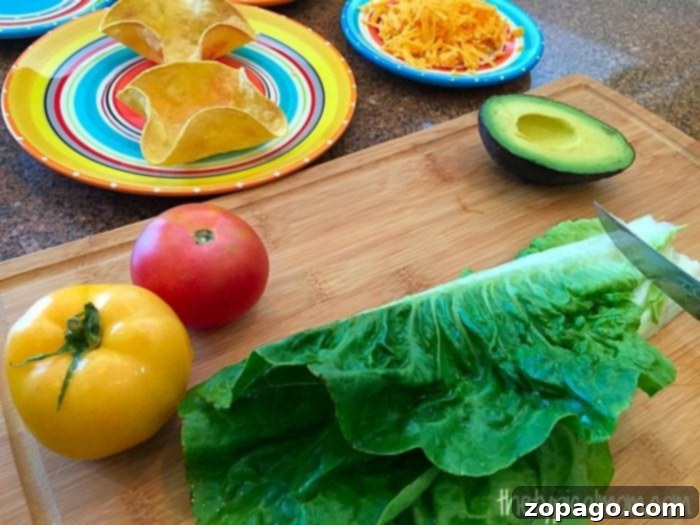 DIY Crispy Taco Bowls 5 Assortment of fresh toppings and crispy taco salad shells on a wooden board, ready for a build-your-own taco bar.