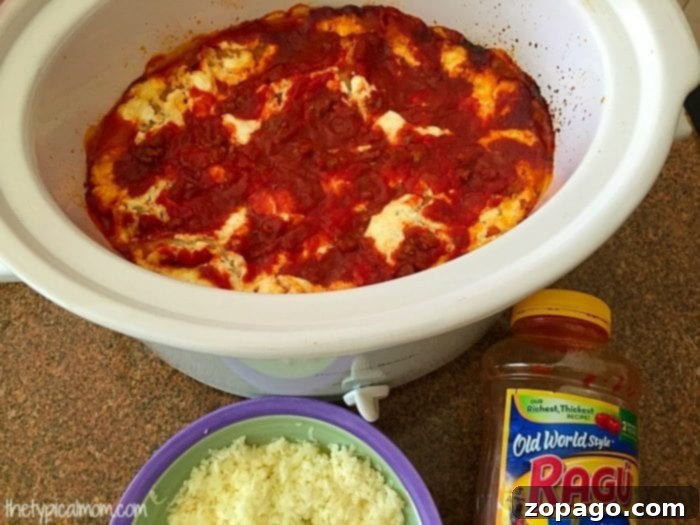 Freshly cooked crockpot lasagna, hot and ready to serve. Cooked crockpot lasagna with melted cheese.