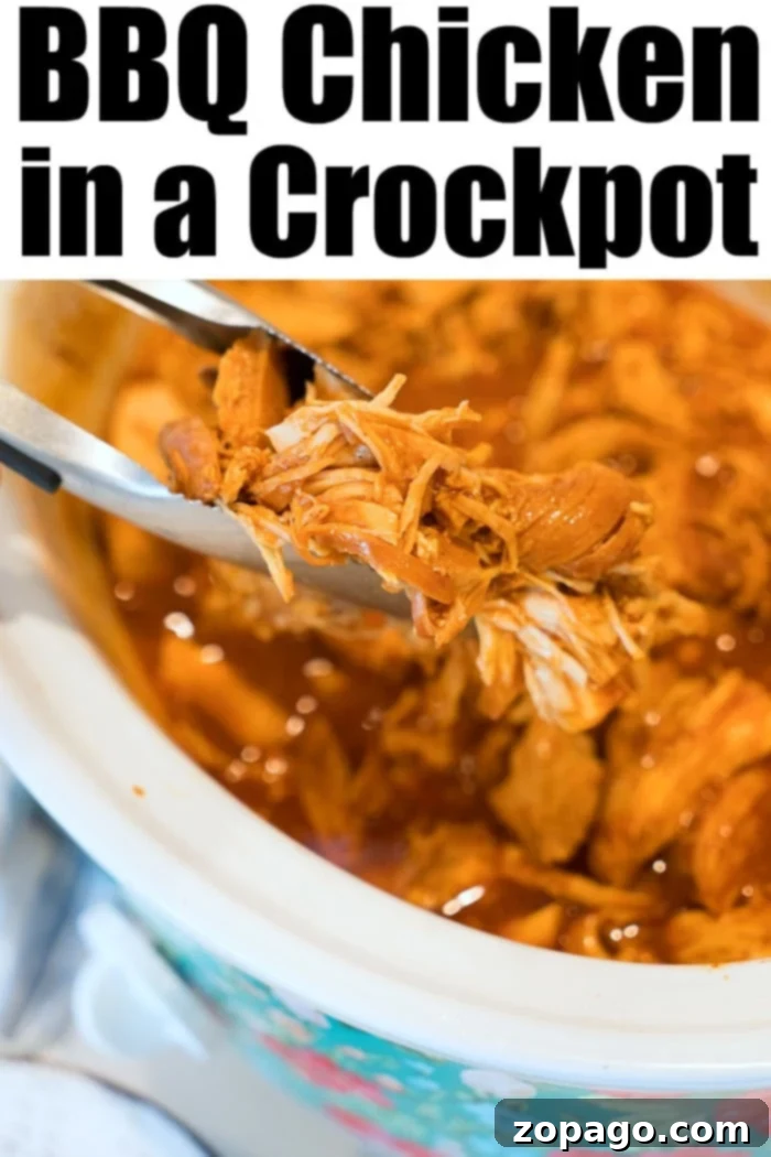 Slow Cooker BBQ Chicken 5 Close-up of shredded BBQ chicken in a crockpot, illustrating perfect tenderness and rich sauce.