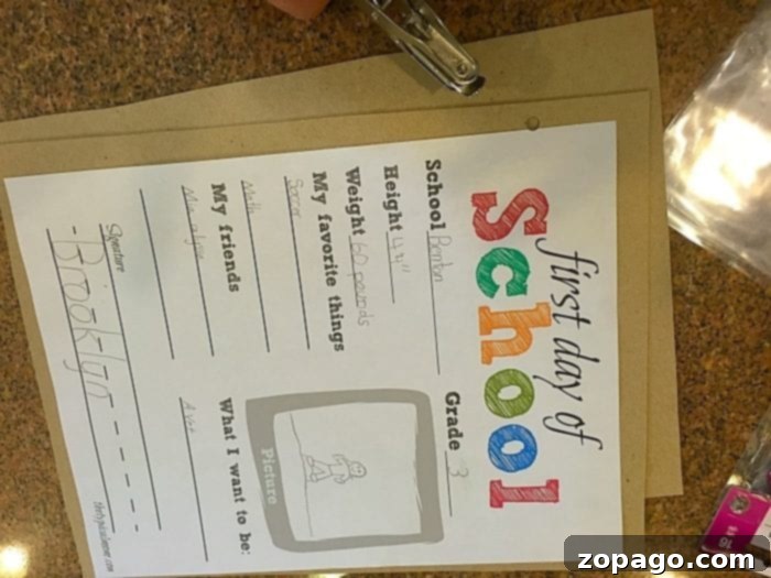 Free First Day of School Printable and Memory Book Ideas First day of school paper taped onto a cereal box, ready for trimming