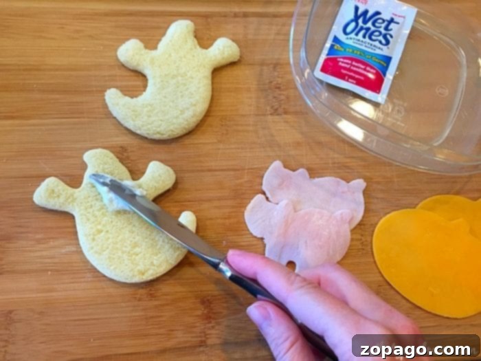 Cookie cutters being used to create fun shapes for a themed school lunch, specifically with a Halloween focus.