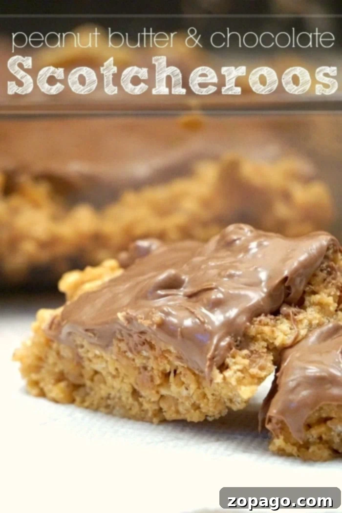 Scotcheroos are the best peanut butter and butterscotch dessert recipe ever that has chocolate in it too. Super easy to make with cereal. Close-up of a single Scotcheroo bar, highlighting the glossy chocolate and butterscotch topping over the crispy peanut butter base.