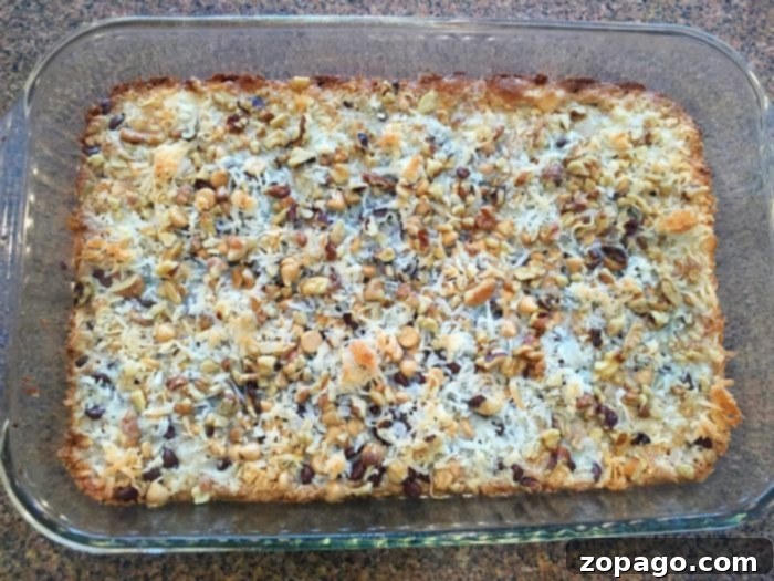 Perfectly baked 5-layer cookie bars, golden brown and ready to enjoy. Warm, chewy, chocolatey Better Than Sex Cookie Bars fresh out of the oven, cut into squares.
