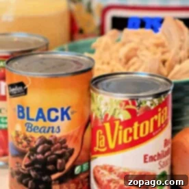 Canned black beans and red enchilada sauce ready for soup