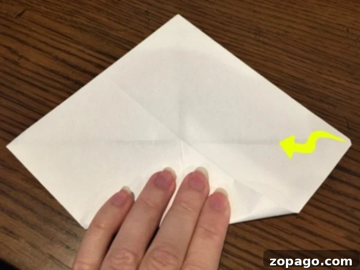 Craft Your Own Fortune Teller 3 Visual guide showcasing a partially folded paper fortune teller, illustrating the initial stages of the DIY craft for educational games.