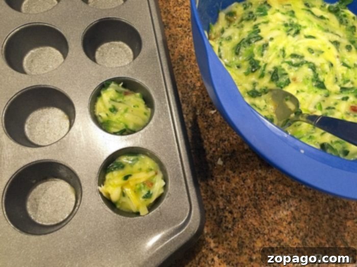 Savory Egg Muffins 2 Crustless spinach quiche recipe close-up on a white plate, highlighting its texture.
