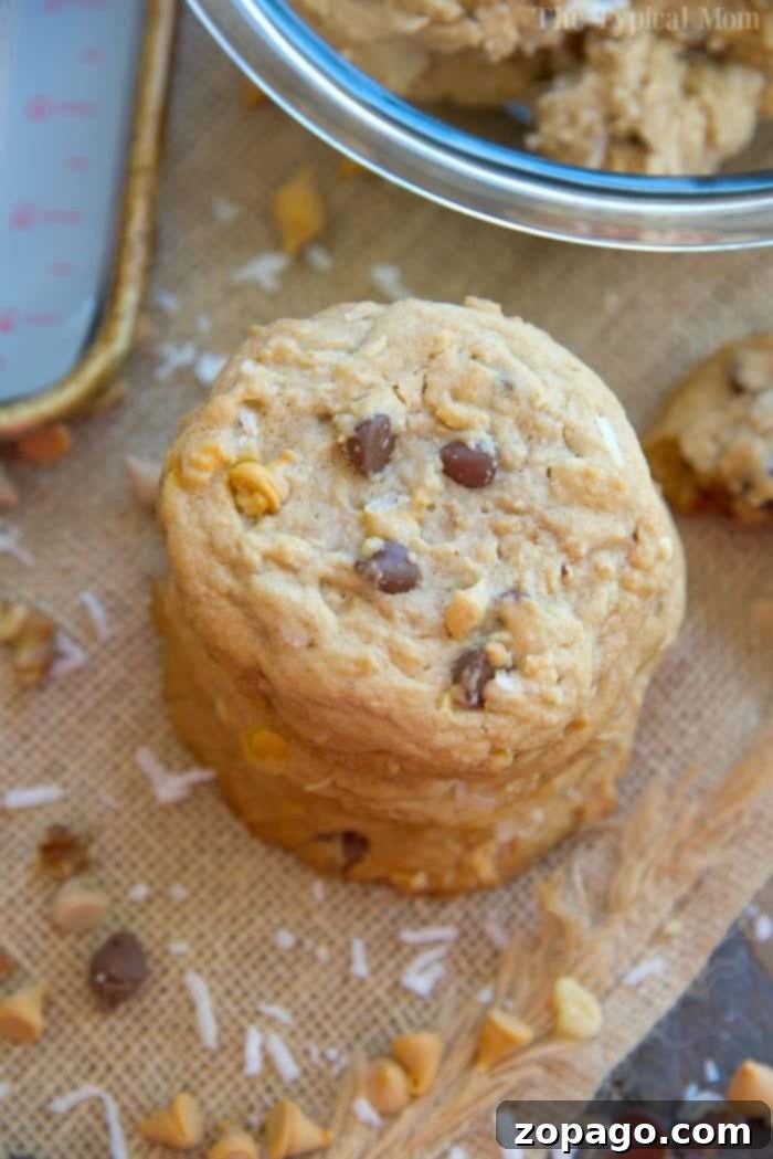 Everything Goes Cookies 8 A stack of freshly baked cowboy cookies, showcasing their rich texture and abundant mix-ins.