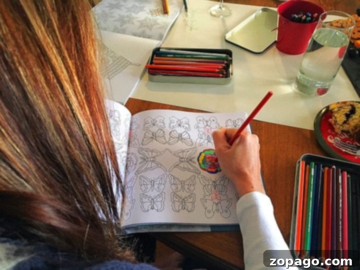 Uncork Creativity Your Guide to a Stellar Color and Sip Party 6 A close-up of a beautifully colored page from an adult coloring book, showcasing vibrant hues and intricate details, surrounded by Prismacolor colored pencils, during a relaxing Color & Sip party with friends.