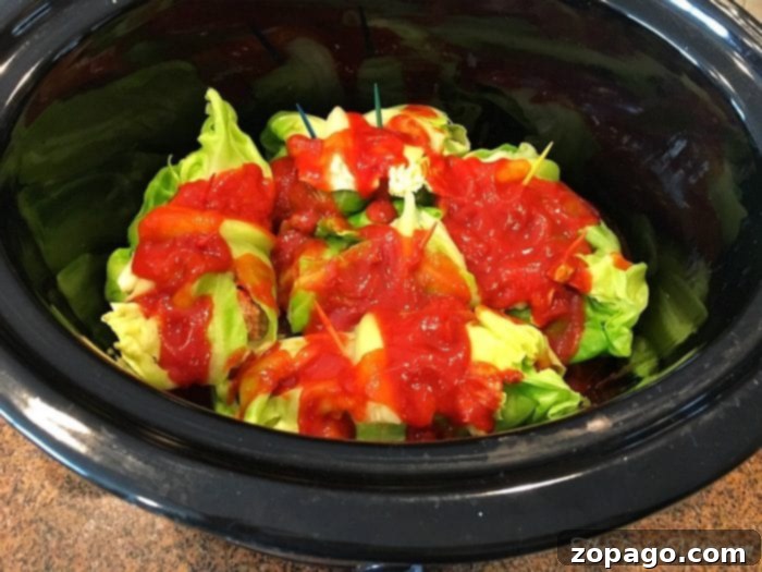 Comforting Slow Cooker Cabbage Rolls 9 Close-up of cooked slow cooker stuffed cabbage rolls in a serving dish