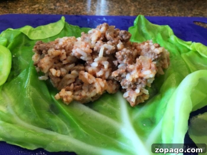 Comforting Slow Cooker Cabbage Rolls 6 Folding the sides of the cabbage leaf over the filling
