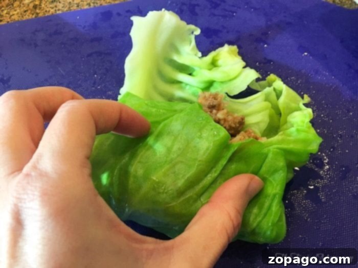 Comforting Slow Cooker Cabbage Rolls 7 Rolling the cabbage leaf into a compact roll