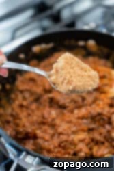 A spoonful of brown sugar held over a pot of simmering ground meat, the irresistible aroma beckons as the perfect prelude to delectable Sloppy Joes.