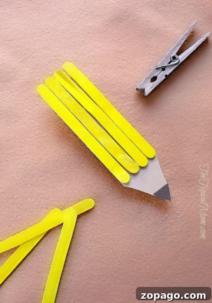Popsicle Stick Magnet Craft: Easy Pencil Design for Kids attaching clothespin to craft