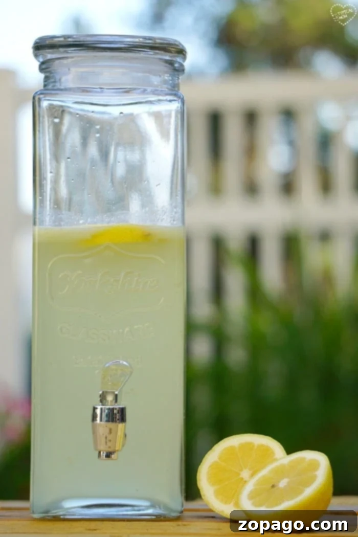 Enjoy the natural goodness of fresh squeezed lemonade for a delicious and healthy treat. Fresh squeezed lemonade being poured, highlighting the refreshing aspect of lemon beverages