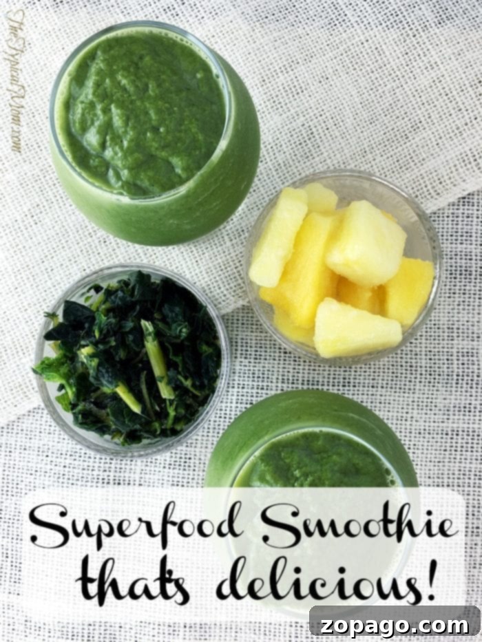 Final Green Superfood Smoothie with Pineapple Presentation Two glasses of green superfood smoothie with pineapple and kale garnish