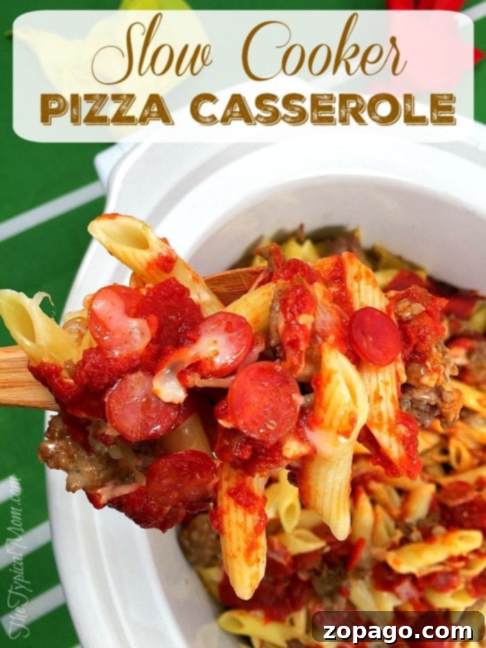 This slow cooker pizza casserole recipe is amazing! So easy to make in your crockpot and great for dinner or a party with kids. #slowcooker #pizza #crockpot #casserole #crockpotrecipes #thetypicalmom Hearty slow cooker pizza casserole with a generous layer of melted cheese.