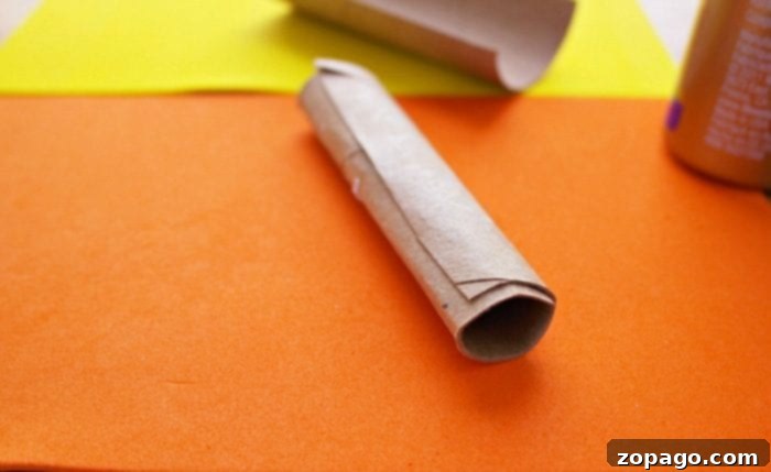 Create Lorax Truffula Tree Finger Puppets 3 Step-by-step image showing a toilet paper roll being cut for a DIY finger puppet craft.