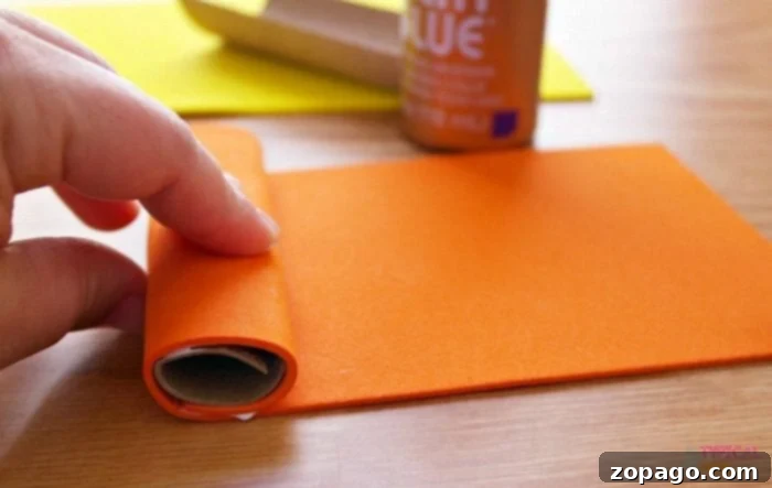 Step 2: Securing the Puppet Base Toilet paper roll curled and glued for Lorax craft