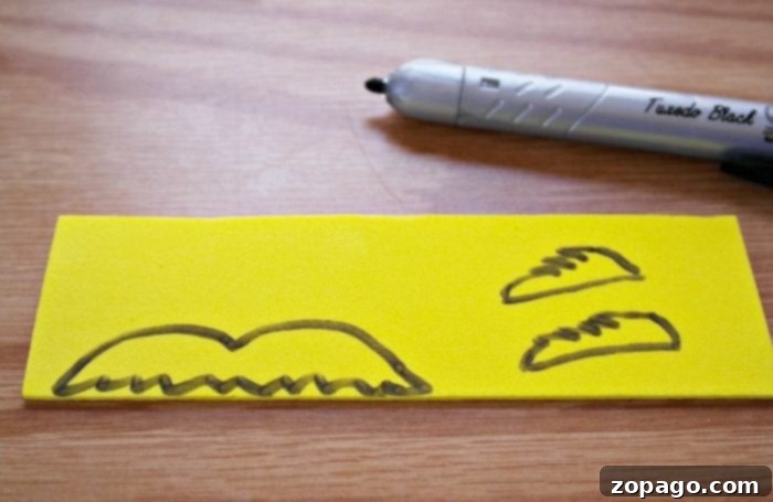 Create Lorax Truffula Tree Finger Puppets 5 A cutout Lorax template on craft foam, showing pieces for the mustache and eyebrows.