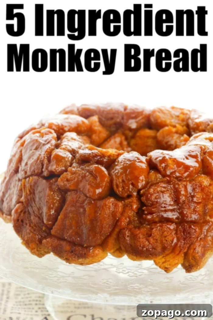 Monkey bread recipe using refrigerated biscuits is easier than you think! Add apples, berries and a drizzle of frosting for the ultimate breakfast. #monkeybread #biscuit #pillsbury #christmasbreakfast #breakfast #brunch #dessert #easy #basic #thetypicalmom The finished easy monkey bread recipe, showcasing its delightful texture and glaze.