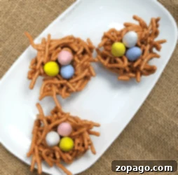 Crispy Butterscotch Clusters 7 Three edible bird nest treats, resembling butterscotch haystacks, garnished with chocolate eggs.
