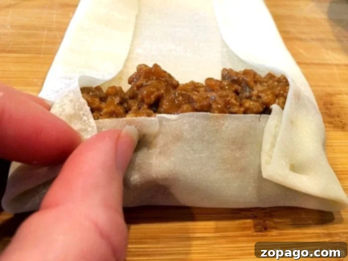 Sloppy Joe Crunch Rolls 3 Assembling Sloppy Joe Egg Rolls on a cutting board
