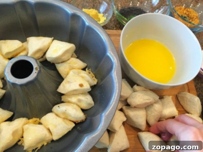 Garlic Cheese Pull-Apart Bread 4 A variety of small bowls filled with different savory toppings for monkey bread, including cheese, herbs, and seeds.