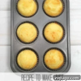 A muffin pan with six freshly baked cupcakes, ready for frosting. A perfect small batch dessert.