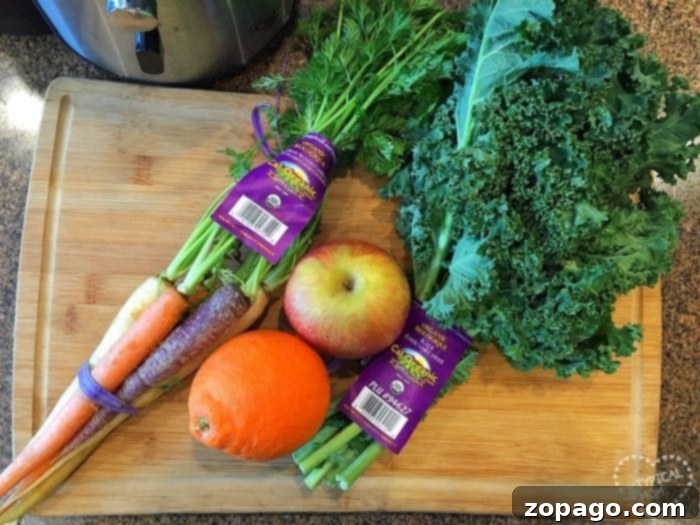 Easy Homemade Kale Juice 5 Carrots, an apple, an orange, kale, and celery sit on a wooden cutting board next to a slow cooker; these are perfect for crafting easy kale recipes.