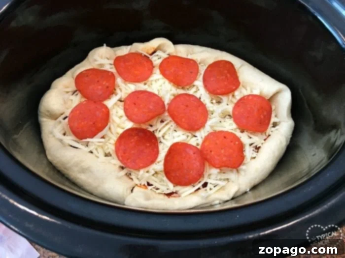 Slow Cooker Pizza 4 Step-by-step image demonstrating how to properly fold rectangular pizza dough into a slow cooker to form a round, thick-edged, deep-dish crust.
