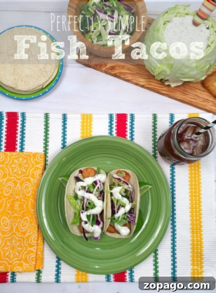 Bright Cilantro Lime Sauce 6 A vibrant plate featuring two fish tacos, generously topped with fresh cabbage and a dollop of creamy Cilantro Lime Sauce, on a colorful placemat.