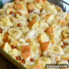 Close-up of an easy homemade banana bread pudding with banana slices and bread cubes in a glass baking dish.