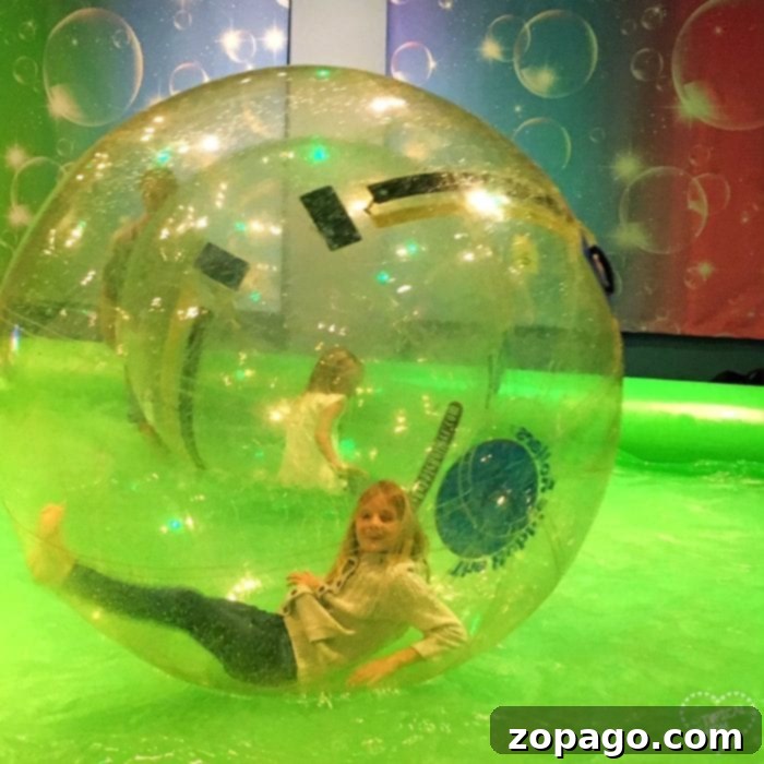 Interactive Bubble Zone at Discovery Cube OC for hands-on fun. Child playing inside a giant bubble at Discovery Cube OC Bubblefest