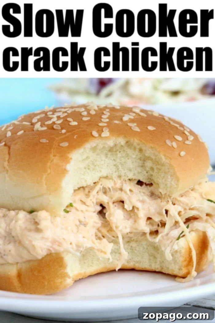 Set-It-and-Forget-It Dinners 4 A close-up of a sesame seed bun sandwich overflowing with creamy, shredded chicken captures the eye. The text Crockpot Crack Chicken is displayed at the top of the image, enticingly highlighting its slow-cooked deliciousness.