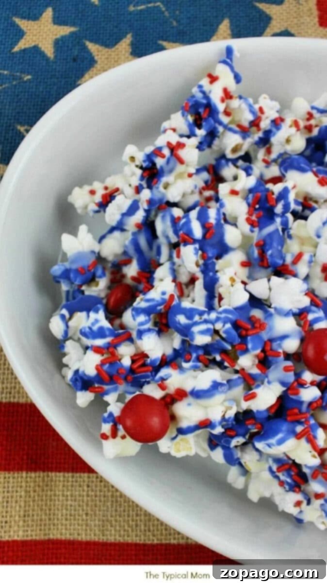 Red, White, and Blue Popcorn recipe is a perfect Memorial Day side dish or 4th of July dessert too. Chocolate popcorn with patriotic colors. Red, White, and Blue Chocolate Drizzled Popcorn - Perfect Fourth of July Party Food