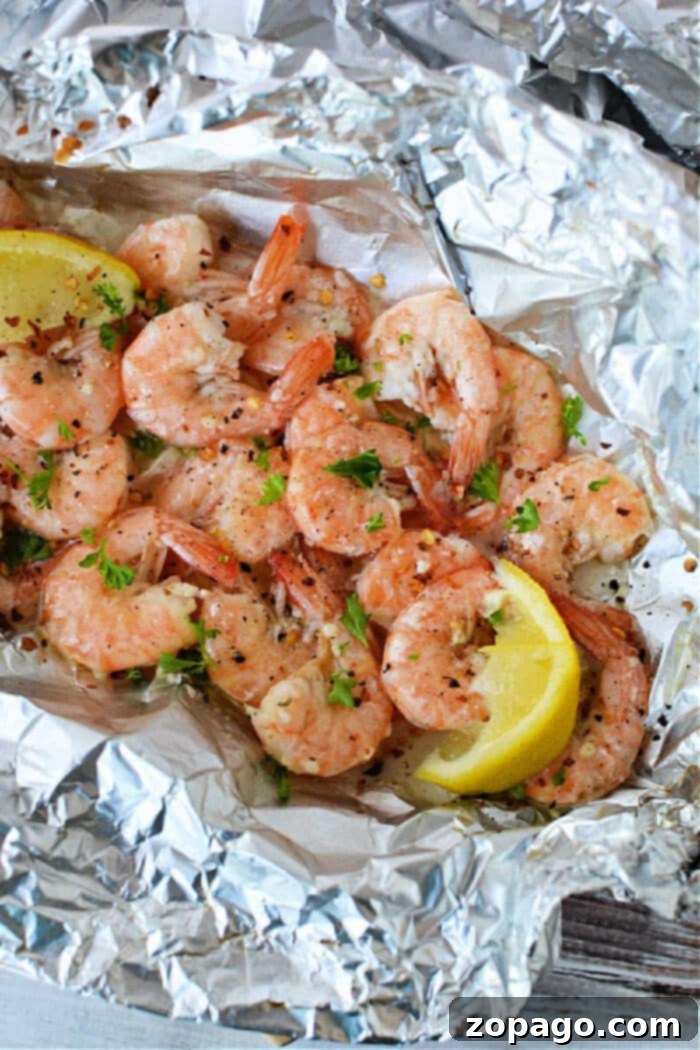 Simple Campfire Feasts for Families 4 Shrimp and vegetables cooking in foil packets over a campfire, illustrating an incredibly easy and delicious camping meal solution.