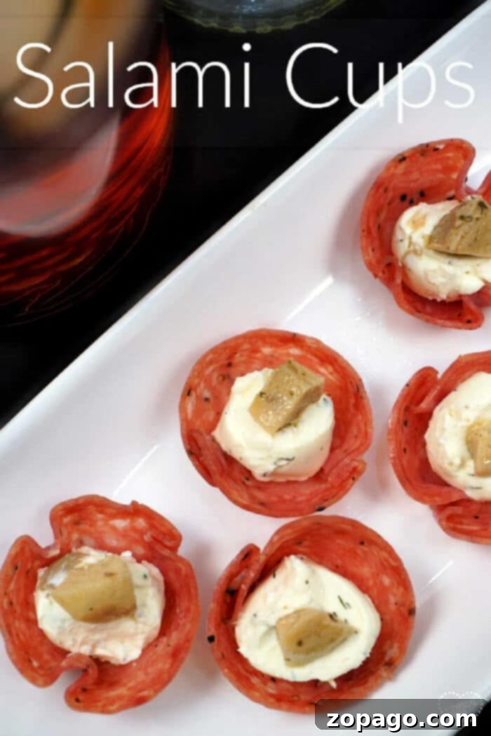 This is how you make salami cups! These are the best bite size cream cheese and artichoke appetizer with salami used as a little cup. You've got to bake these and serve them at your next Super Bowl party or just because friends are coming over. #salami #baked #cups #appetizer #creamcheese #artichoke #fingerfood #superbowl EASY-salami-appetizer-with-cream-cheese-and-artichoke.-The-most-amazing-salami-cups-youll-ever-serve on a serving platter with more appetizers.