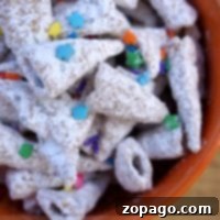 A bowl brimming with powder-coated Bugles, reminiscent of unicorn horns, adorned with vibrant star and round sprinkles. A magical no-bake dessert.