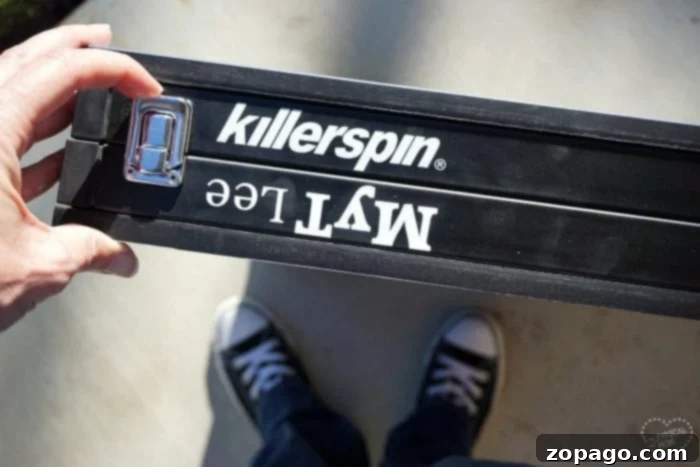 Killerspin Mini Ping Pong Table Review Performance and Portability 3 Reviewer demonstrating the portability of the Killerspin mini ping pong table with ease.