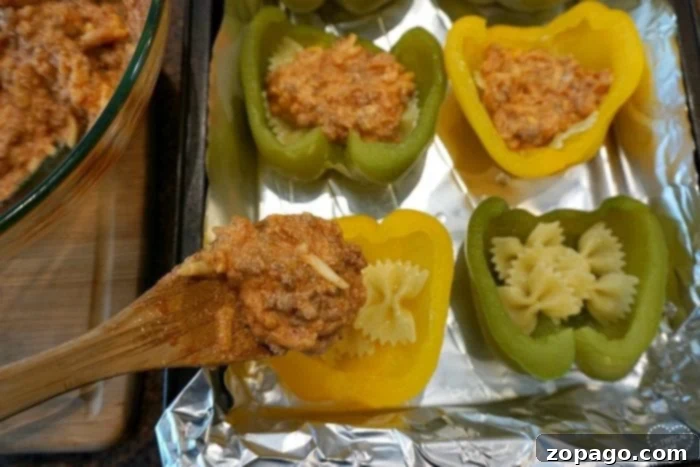 Cheesy Lasagna Stuffed Bell Peppers 5 Stuffed bell peppers arranged in a baking dish, ready for the oven.
